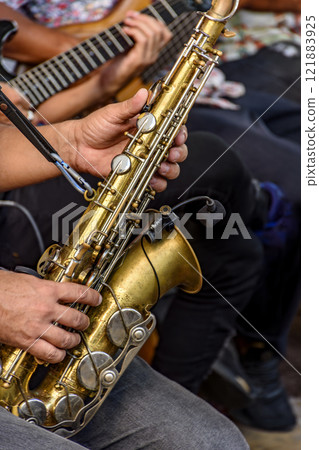 Saxophonist and other instrumentalists 121883925