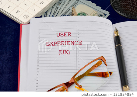 Business concept. Copy space. USER EXPERIENCE written in a business notebook, a conceptual photo 121884884