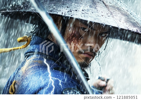Samurai warrior standing defiantly in rain with blood on face 121885051
