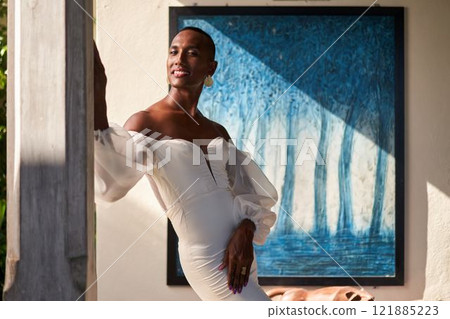 Gender-fluid person in white bridal dress stands elegantly in villa, sunlight casting shadows. Pride month, embracing identity, inclusivity. Serenity in luxurious setting, confident pose. Gender-fluid person in white bridal dress stands elegantly in villa, sunlight casting shadows. Pride month, embracing identity, inclusivity. Serenity in luxurious setting, confident pose. 121885223