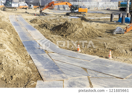 A view of steel plates laid at a construction site A view of steel plates laid at a construction site 121885661
