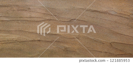 Shimmering Gold Sand Texture with Subtle Layered Patterns and Glittering Highlights 121885953