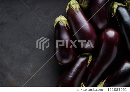 Fresh Farm-to-Table Eggplants on Dark Surface for Rural Economy and Organic Farming, Top View, Copy Space Fresh Farm-to-Table Eggplants on Dark Surface for Rural Economy and Organic Farming, Top View, Copy Space 121885961