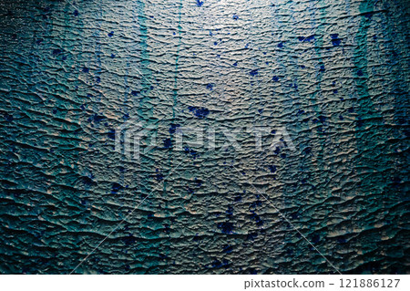 A detailed close up view of a blue surface featuring numerous spots 121886127