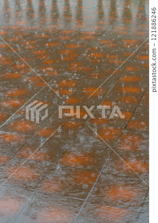 A close up view of a very wet tiled floor during the rainfall 121886246