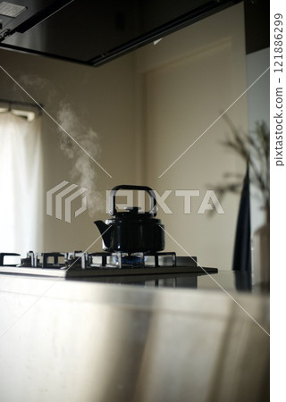 Steam rising from a kettle on the fire Steam rising from a kettle on the fire 121886299