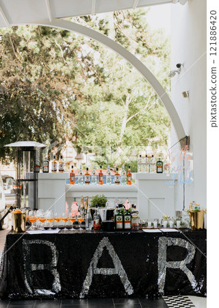 A bar with a black sequined tablecloth and the word bar on it 121886420