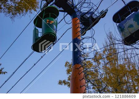 Odessa cable car. Against the backdrop of a blue sky are the cabins of the cable car that connects the French Boulevard with Otrada Beach. Odessa cable car. Against the backdrop of a blue sky are the cabins of the cable car that connects the French Boulevard with Otrada Beach. 121886609