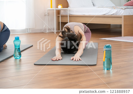 Asian women are exercising with yoga poses, health and wellness concept, exercise 121888937