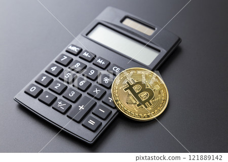 黑色背景下的比特幣和計算器 121889142