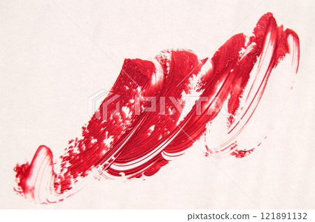 Close-up of a red lipstick smear on a white background 121891132