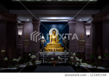 Golden Buddha statue in serene temple setting at Wat Panyanantaram on October 7, 2023 in Phathum Thani, Thailand Golden Buddha statue in serene temple setting at Wat Panyanantaram on October 7, 2023 in Phathum Thani, Thailand 121891140
