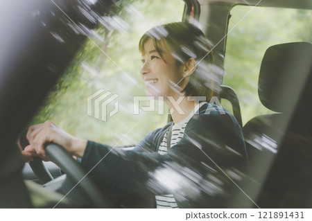 Women driving alone Women driving alone 121891431
