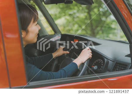 Women driving alone Women driving alone 121891437