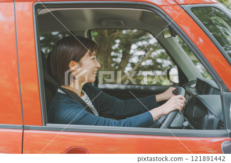 Young woman driving a car Young woman driving a car 121891442
