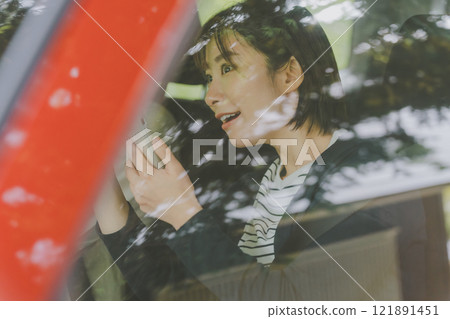 A woman in the passenger seat searches for a route using a smartphone map app A woman in the passenger seat searches for a route using a smartphone map app 121891451