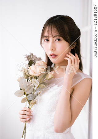 A young woman with long black hair wearing a wedding dress A young woman with long black hair wearing a wedding dress 121891607