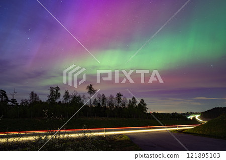 A night view adorned with the aurora and car light trails A night view adorned with the aurora and car light trails 121895103