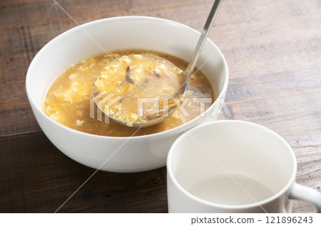 Serve hot and sour soup 121896243