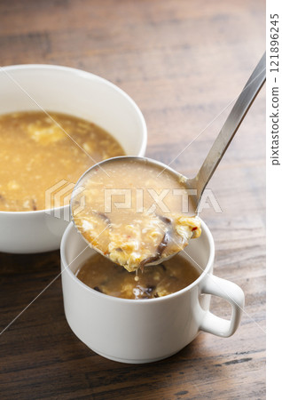 Serve hot and sour soup Serve hot and sour soup 121896245