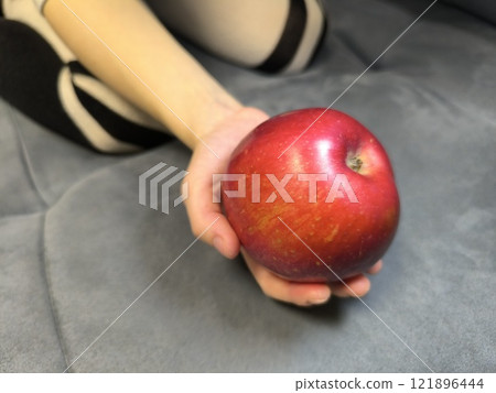 red apple held by human hands red apple held by human hands 121896444