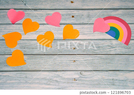 Paper hearts along with rainbow placed on wooden surface Paper hearts along with rainbow placed on wooden surface 121896703