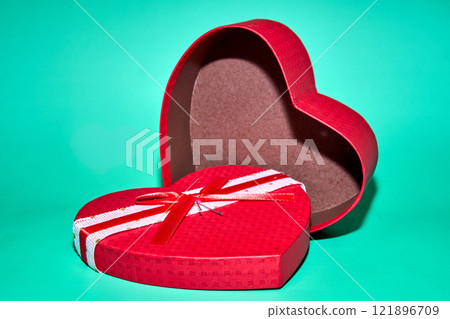 red heart shaped box, open, on a teal background red heart shaped box, open, on a teal background 121896709