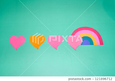 Hearts alongside a rainbow on a teal background Hearts alongside a rainbow on a teal background 121896712