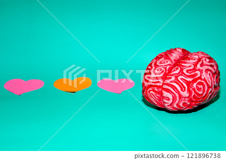 Brain with pink heart on teal 121896738