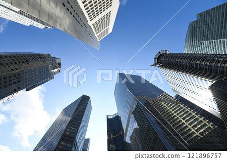 Low-angle building view of the modern office skyscrapers in the financial district of Raffles Place, Singapore. 121896757