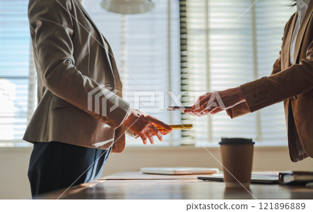 A scene where something is exchanged digitally 121896889