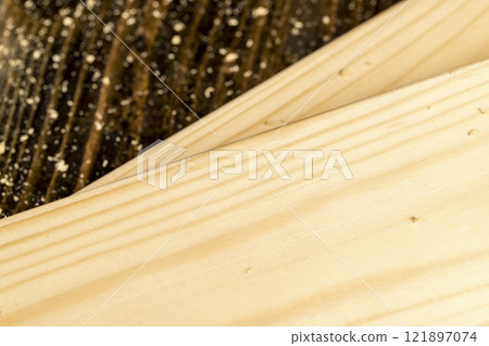 metal drill bit and pine wood board during operation 121897074