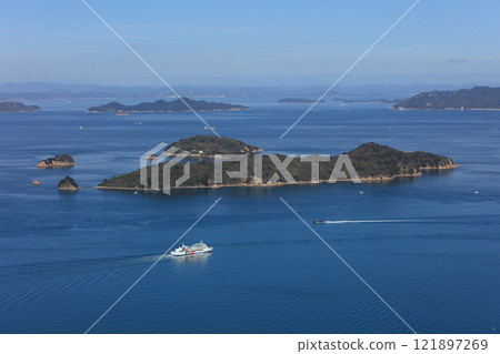 An international ferry heading to Shodoshima in the Bisan Seto Strait off the coast of Takamatsu in the Seto Inland Sea (Oshima in the foreground, Shodoshima in the background to the right) 121897269