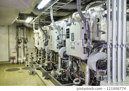 Absorption hot and cold water machine installed in the basement. Photo courtesy of Denpa Gakuen, Tokyo Electronics College. 121898774