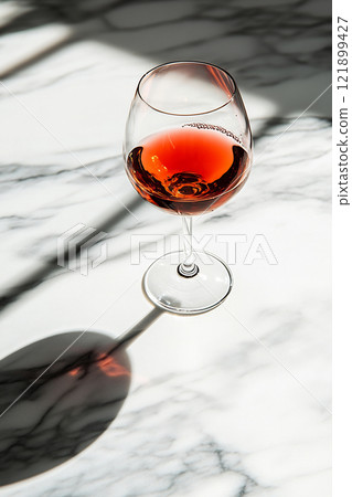 Glass of rose wine on marble surface Glass of rose wine on marble surface 121899427