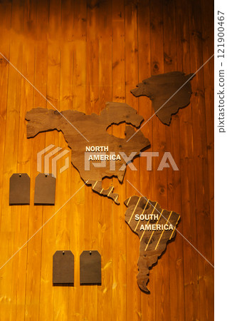 wooden world map on a wooden background. the world's continents in a smaller version 121900467