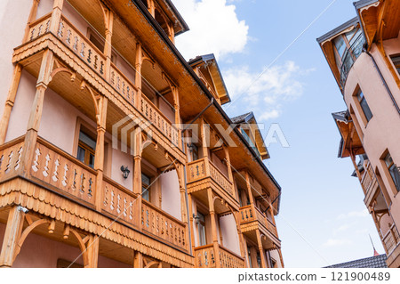 Wooden balcony of a wood house. Exterior facade 121900489