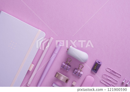 Pastel light purple office supplies, paper clips, pens, clips, pins, eraser, sharpener, stapler. Space for your text. 121900590