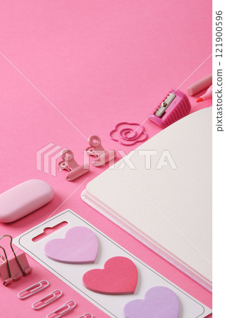 Stationery background in pink theme, open notepad sheet and office supplies. A place for your text. 121900596