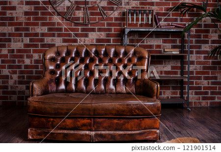 Old leather sofa. Brown furniture. Retro bed with a soft back. Old leather sofa. Brown furniture. Retro bed with a soft back. 121901514