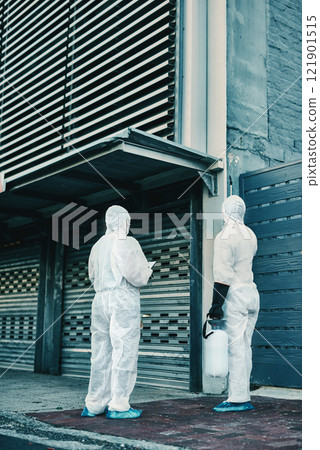Medical team and covid hygiene healthcare workers wearing hazmat suits for safety while at quarantine site outside. In protective gear for cleaning, disinfection and decontamination to fight virus Medical team and covid hygiene healthcare workers wearing hazmat suits for safety while at quarantine site outside. In protective gear for cleaning, disinfection and decontamination to fight virus 121901515