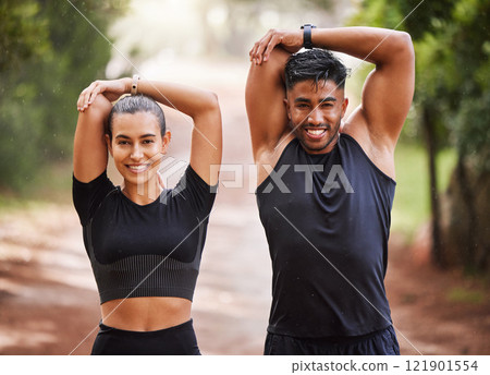 Fit couple or active, athlete friends stretching arms for exercise warmup outdoors in forest. Workout partners or smiling joggers about to run or do cardio training for health and wellness lifestyle. 121901554