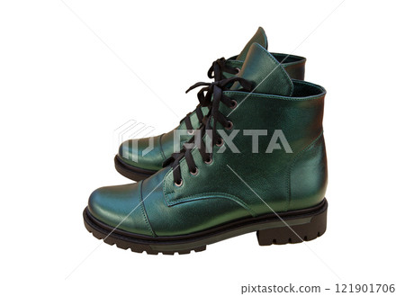 Green leather shoes isolated on white background. Winter and spring off-season boots. Stylish boot. Close-up. Laces, tractor sole. Casual style. Pearlescent fashionable color 121901706