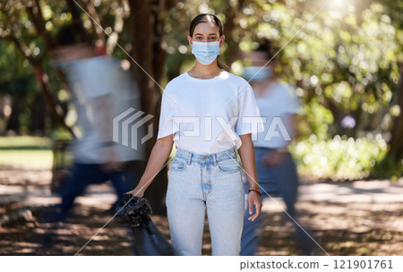 Woman in covid face mask cleaning the park for clean, hygiene and safe green environment. Responsible activist, volunteer or community service worker with rubbish, trash and garbage in a plastic bag Woman in covid face mask cleaning the park for clean, hygiene and safe green environment. Responsible activist, volunteer or community service worker with rubbish, trash and garbage in a plastic bag 121901761