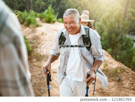 Hike, trekking sticks and senior male walking with friends for fitness and health in nature. Healthy, active and smiling mature man hiking with a backpack. Old group on an outdoor wellness adventure 121901765