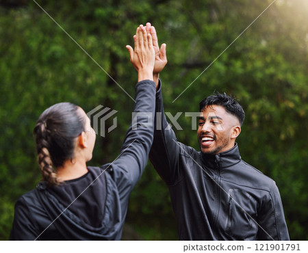 Active, fit and sporty athletes doing a high five to celebrate and congratulate on fitness goals. Healthy, happy and exercising couple motivated after training, getting cardio workout outside 121901791