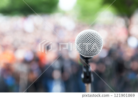 Microphone in focus against blurred protest or public demonstration Microphone in focus against blurred protest or public demonstration 121901869