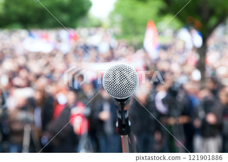 Microphone in focus against blurred protest or public demonstration 121901886