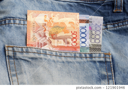 Kazakhstani tenge in the pocket of blue jeans Kazakhstani tenge in the pocket of blue jeans 121901946