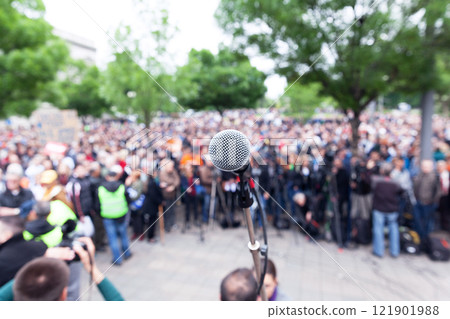 Microphone in focus against blurred protest or public demonstration 121901988